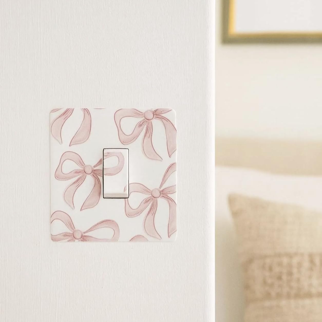Decorative pink bow vinyl sticker fitted to a UK light switch