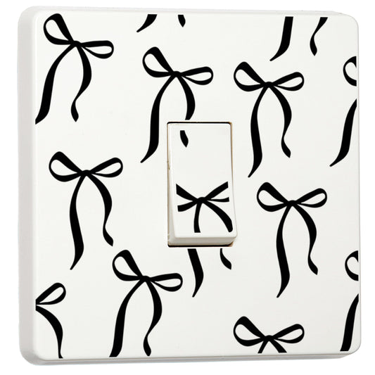 Set of 2 black bow light switch stickers for a compatible UK single switch