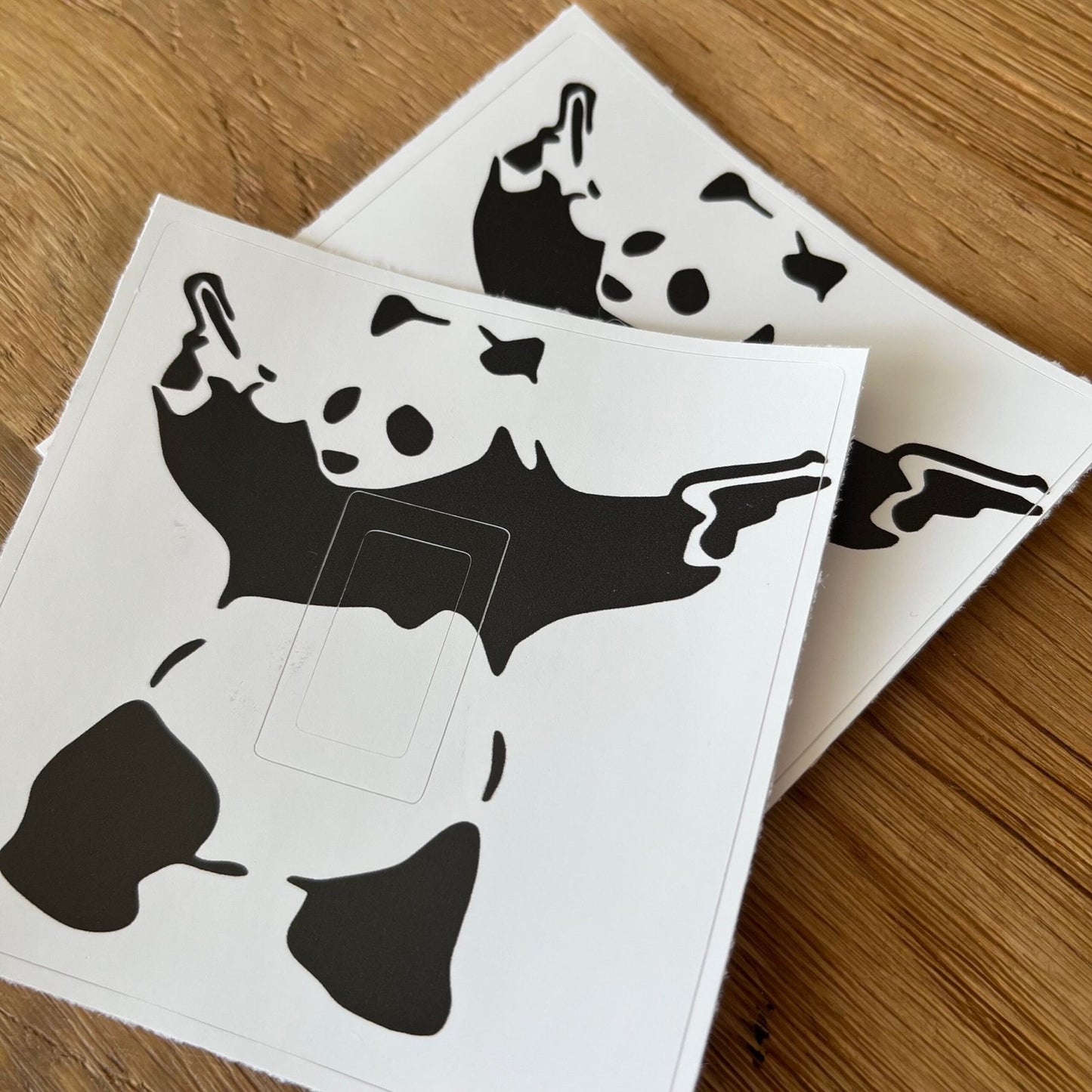Self-adhesive Banksy Panda sticker for a light switch faceplate