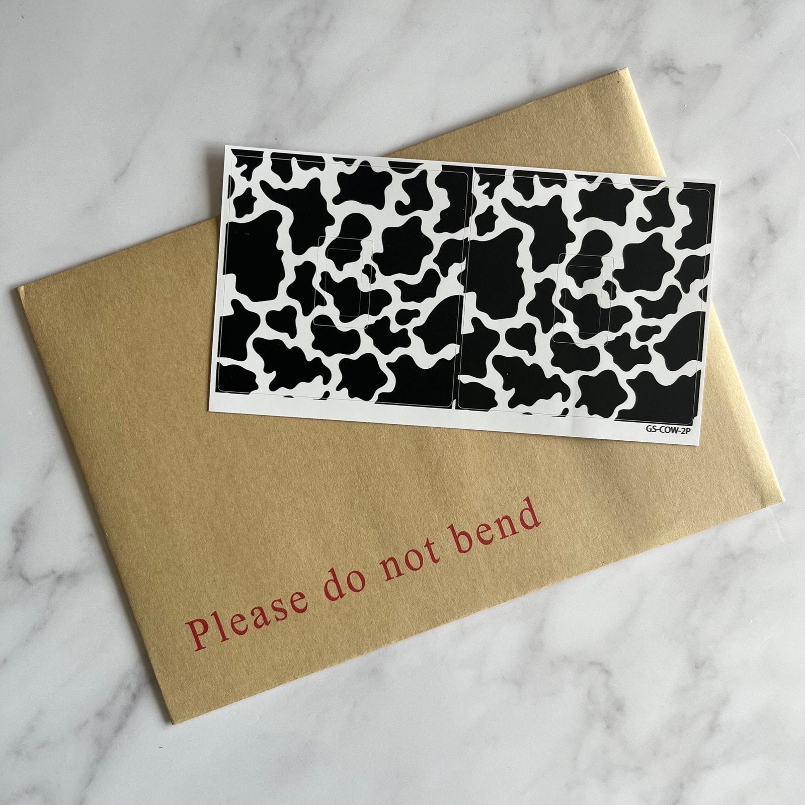 Self-adhesive Cow Print sticker for a light switch faceplate
